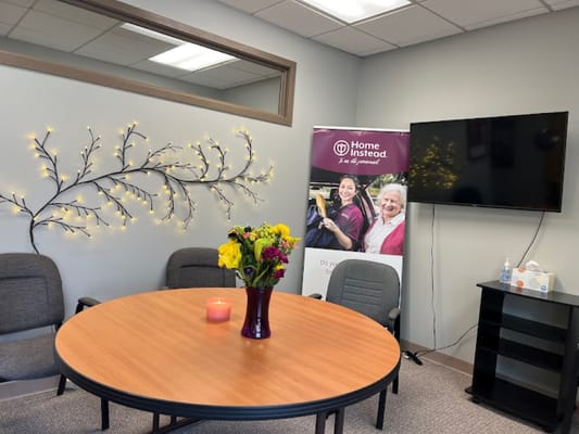Cozy common area with a round table and decorative wall