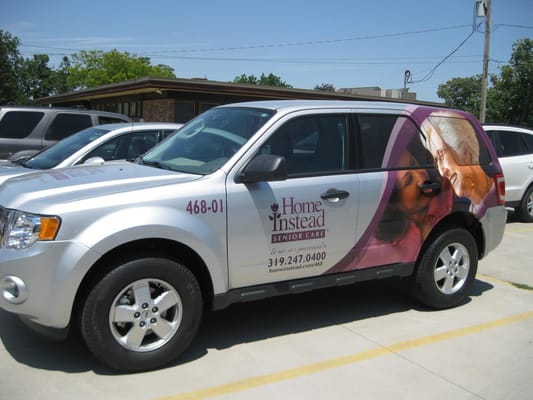 Branded Home Instead senior care vehicle parked outside