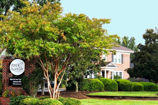 Exterior view of hospice facility showing building and landscaping