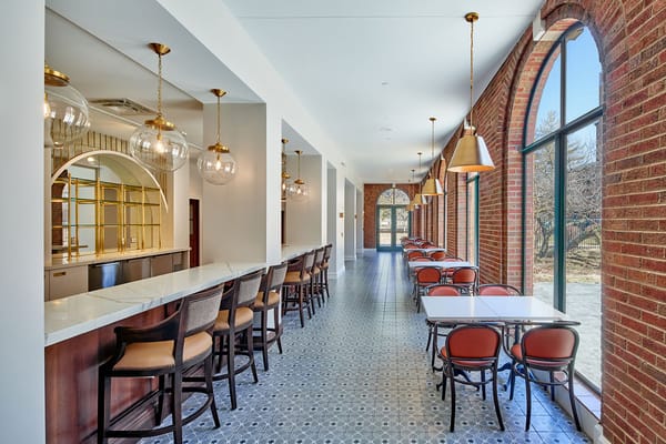 Bright dining area with bar seating and large windows