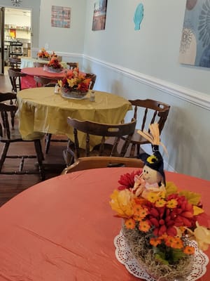 Decorated dining area with autumn-themed centerpieces
