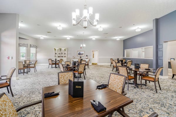 Dining area with tables and chairs set up for meals