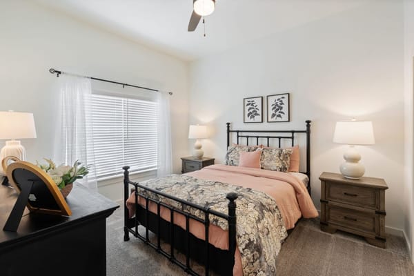 Cozy private resident room with decorative bedding and lamps