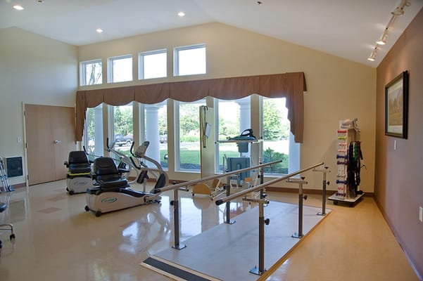 Interior of the therapy room with exercise equipment and large windows