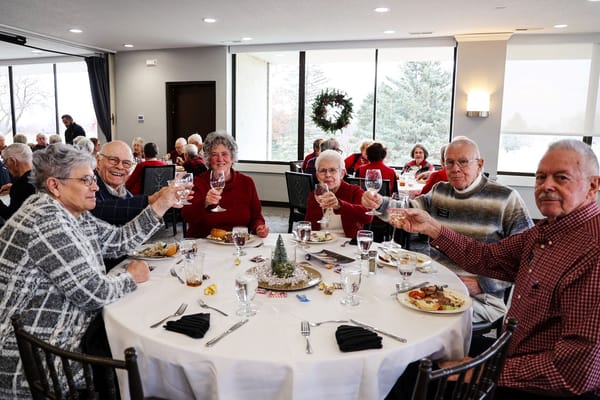 Residents toasting at a festive dining event