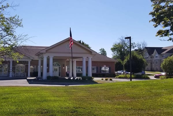 Facade of Meadow Park Rehabilitation & Healthcare Center with an American flag