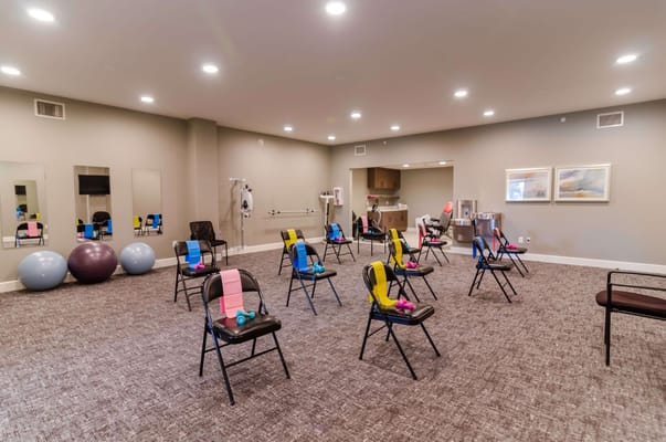 Empty exercise room with chairs and fitness equipment