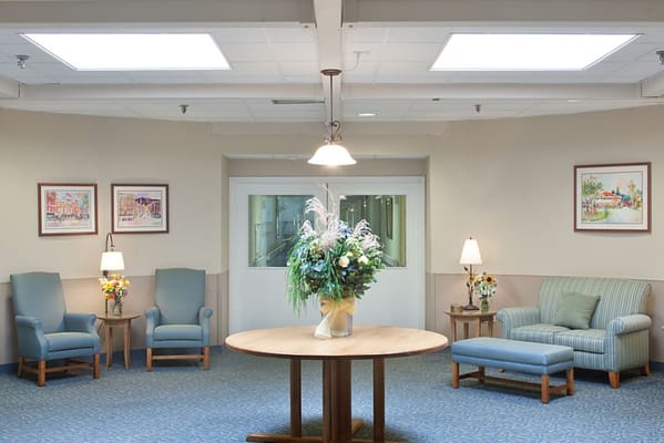 Bright common area with seating and floral arrangement