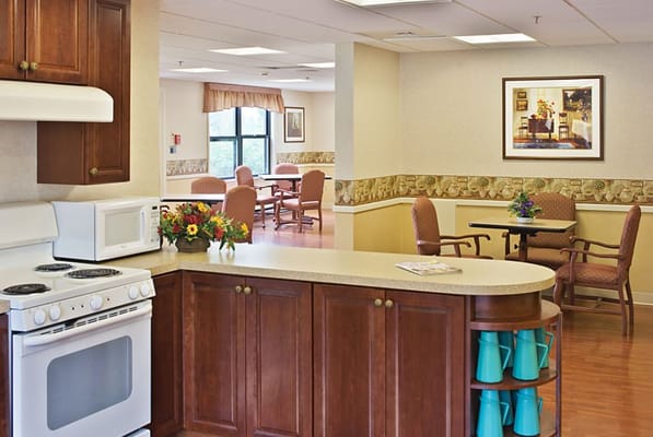 Bright common area with seating and kitchenette
