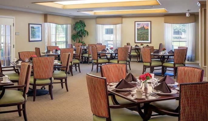 Dining area with tables set for residents