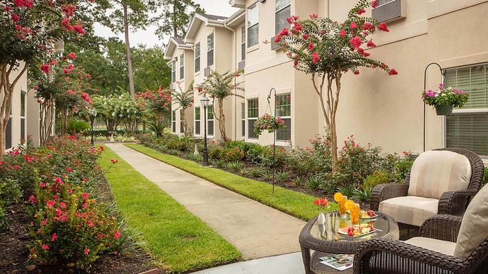 Garden walkway surrounded by blooming flowers