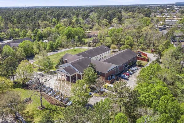 Aerial view of the assisted living facility with surrounding greenery