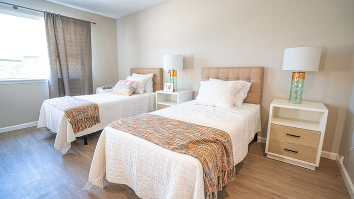 Bright interior of a resident room with two beds
