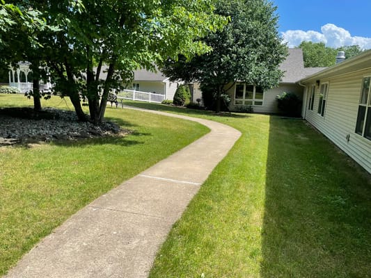 Curved walking path surrounded by lush greenery at Oakwood Terrace.