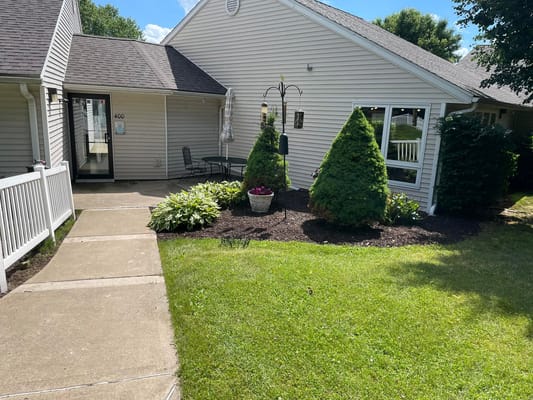 Pathway leading to the entrance of Oakwood Terrace with landscaped gardens.