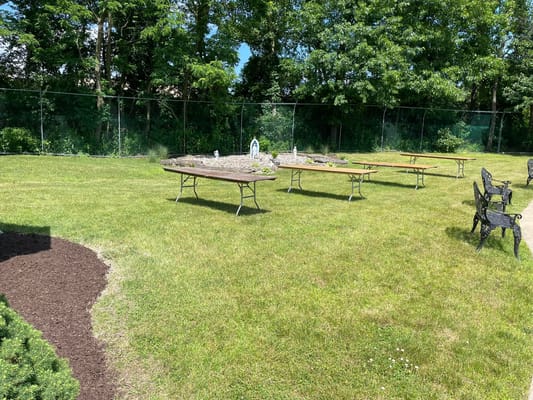 Outdoor seating area with picnic tables and landscaping