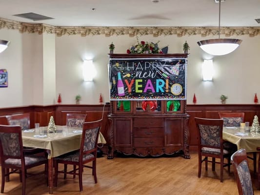 Decorated dining area with a New Year banner and festive table settings