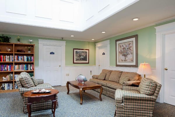 A cozy lounge area with seating and bookshelves