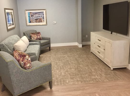 Comfortable seating area with two chairs and a TV