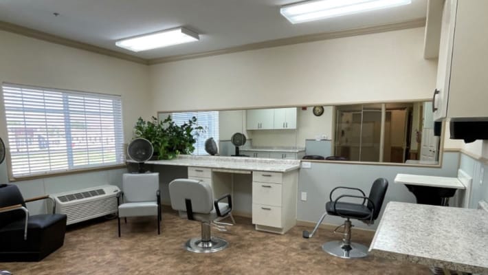 Bright salon area with styling chairs and mirrors