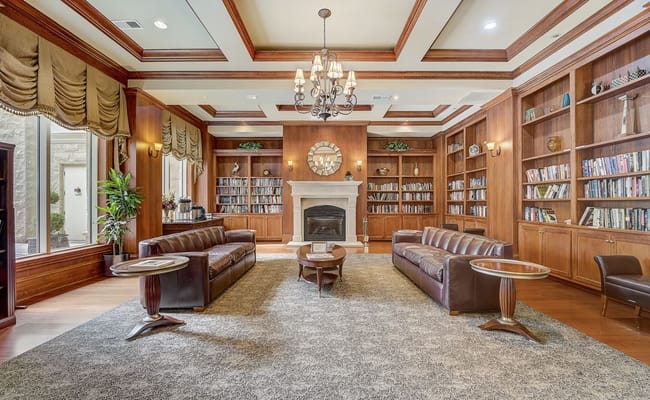 Cozy library lounge featuring leather sofas and bookshelves