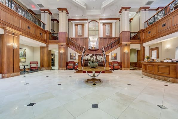 Spacious lobby with a grand staircase and seating area