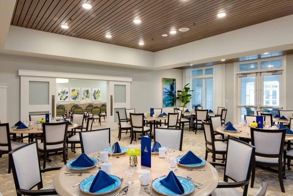 Bright dining area with tables set for residents