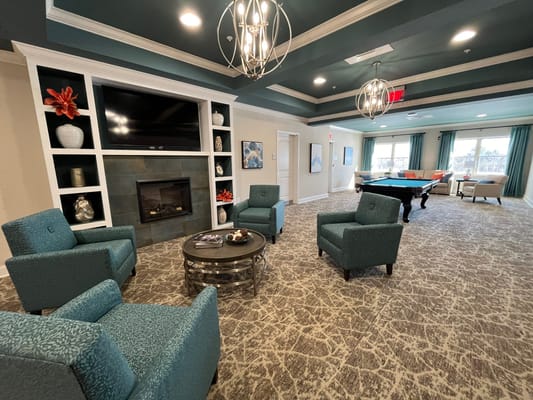 Lounge area with seating and fireplace at Avalon Assisted Living
