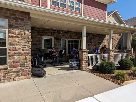 Musicians performing on a covered patio at the facility