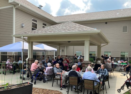 Residents enjoying an outdoor activity under a patio