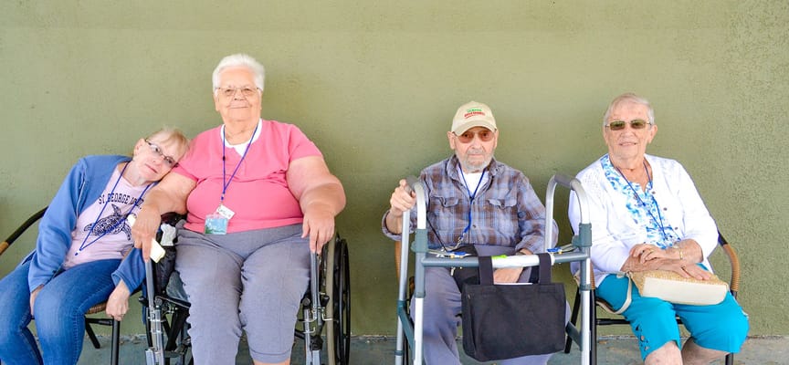 Four residents sitting together outside