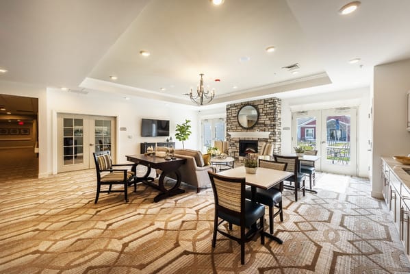 Bright common area with seating and a fireplace