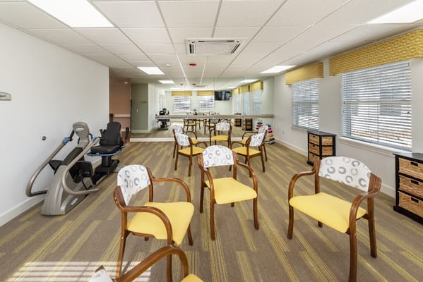 Interior view of a fitness area with empty chairs and equipment
