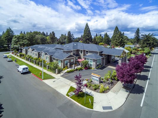 Aerial view of River Terrace Memory Care facility with landscaped entrance.
