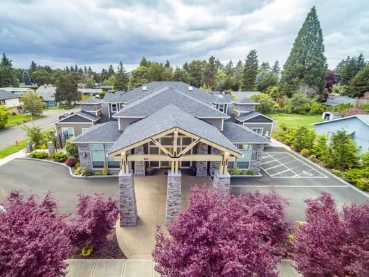 Exterior view of River Terrace Memory Care with landscaped area