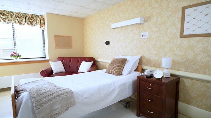 Cozy resident room with a bed and seating