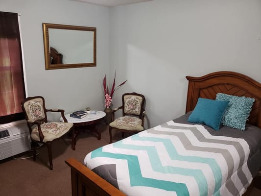 Cozy resident room with bed and seating area