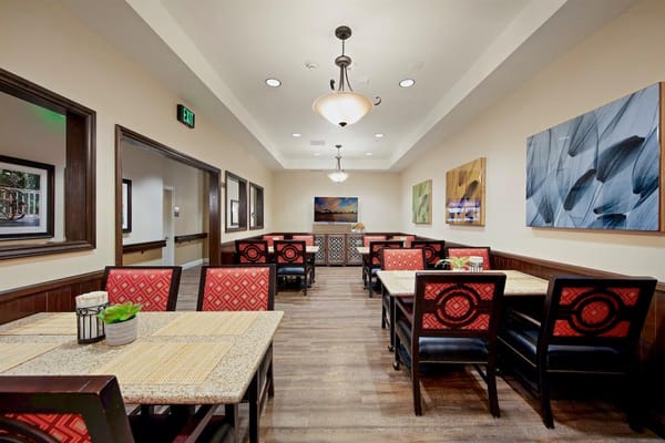 Cozy dining room with tables and artwork