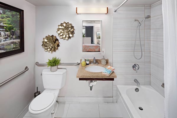 Modern bathroom with sink, shower, and decorative elements.