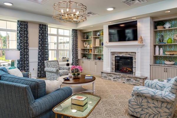 Cozy common area with seating and decorative fireplace
