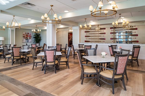 Bright dining room with tables and chairs.