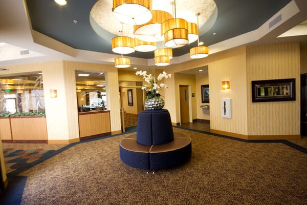 Spacious lobby with decorative lighting and floral centerpiece