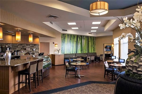 Cozy lounge area featuring a coffee bar and seating with bamboo decor