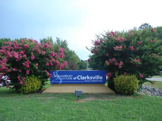 Signage for Signature HealthCARE of Clarksville surrounded by flowers