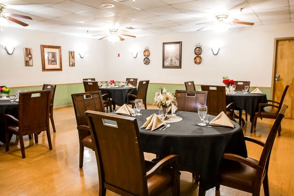 Elegant dining room setup with tables and flowers