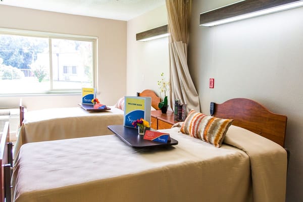 Two beds in a welcoming resident room with decorations
