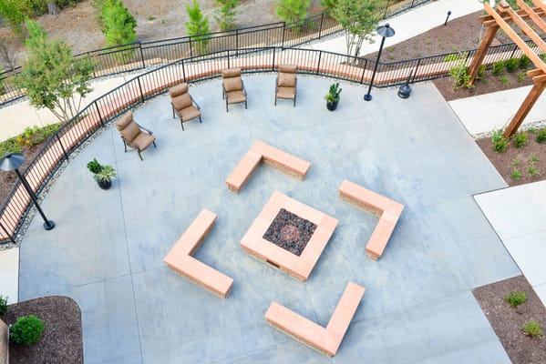 Aerial view of an outdoor patio featuring a fire pit and seating