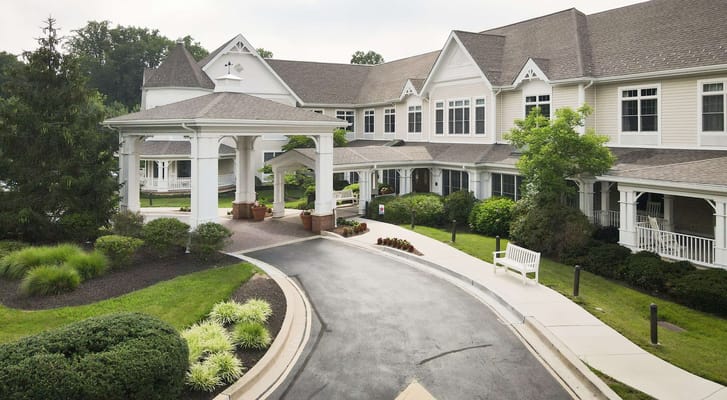 Main entrance with a covered portico and green landscaping