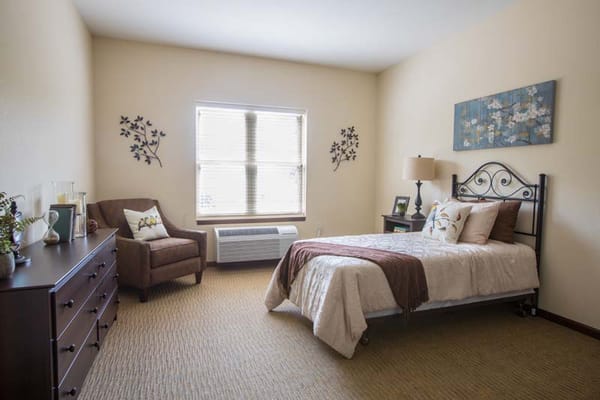 Cozy resident room with a bed and chair