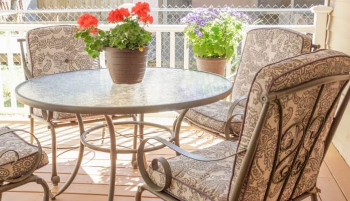 Outdoor seating area with flowers and decorative chairs
